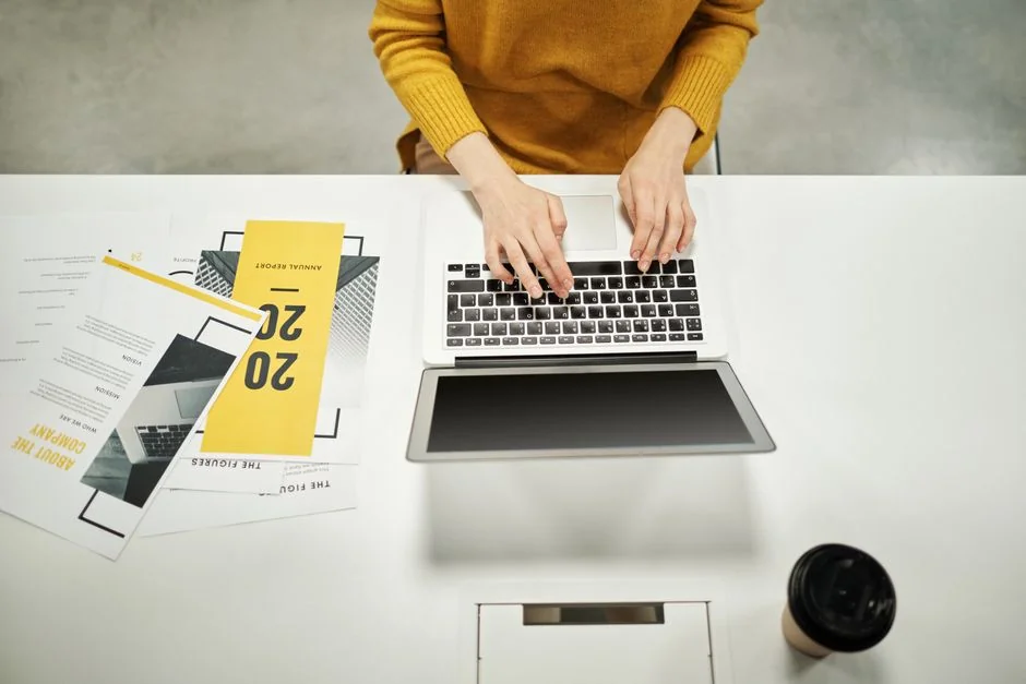 A stylish workspace featuring a laptop and monitors displaying design software.
